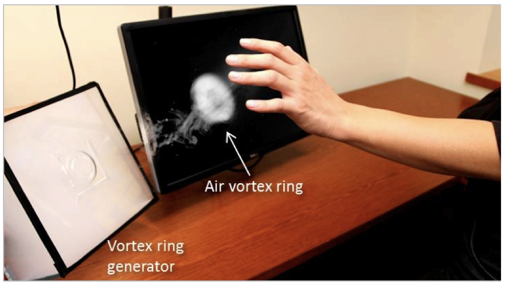 The AirWave prototype emits a vortex of smoke to prove non-contact haptic stimulation.